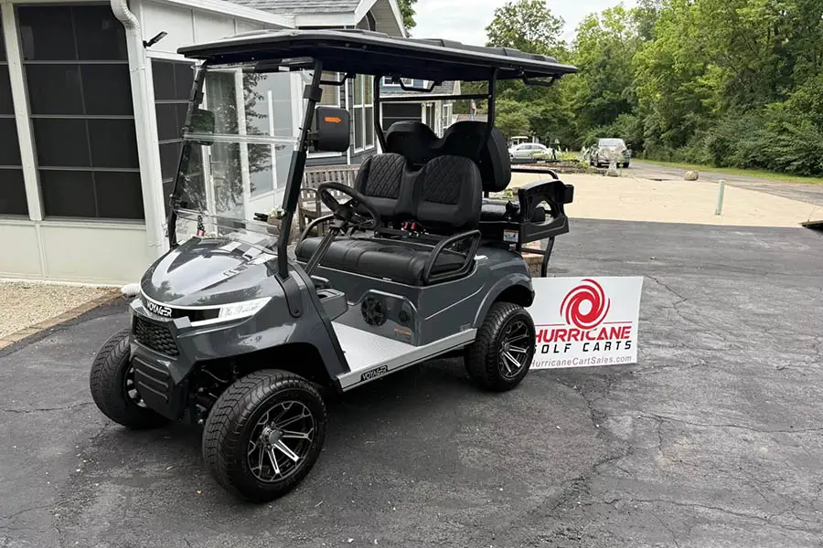 Street-legal golf cart for sale in Indianapolis, IN from Hurricane Golf Carts, showing upgraded seats, roof, and wheels
