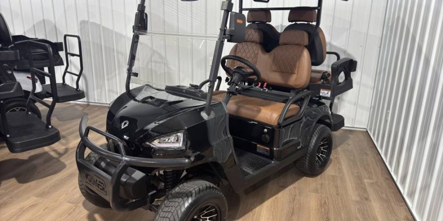 Black Voyager electric golf cart with brown diamond-stitched seats and off-road wheels on display at the Hurricane Golf Carts showroom in Winchester, KY