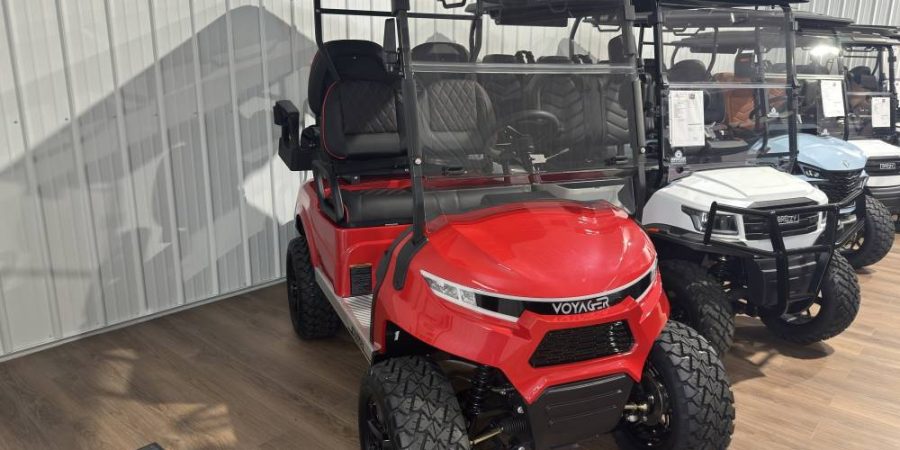 Red Voyager 4 electric golf cart with black diamond-stitched seats at Hurricane Golf Carts showroom in Winchester, KY.