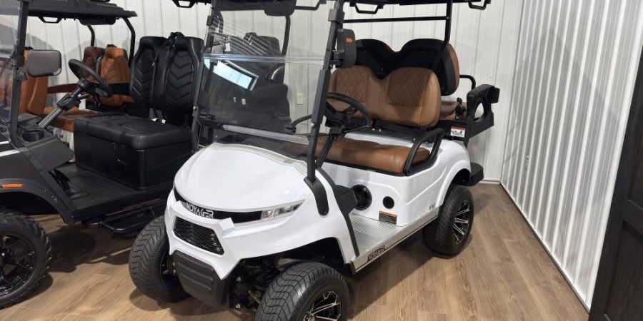 White Voyager 4 lifted electric golf cart with brown diamond-stitched seats for sale at Hurricane Golf Carts.