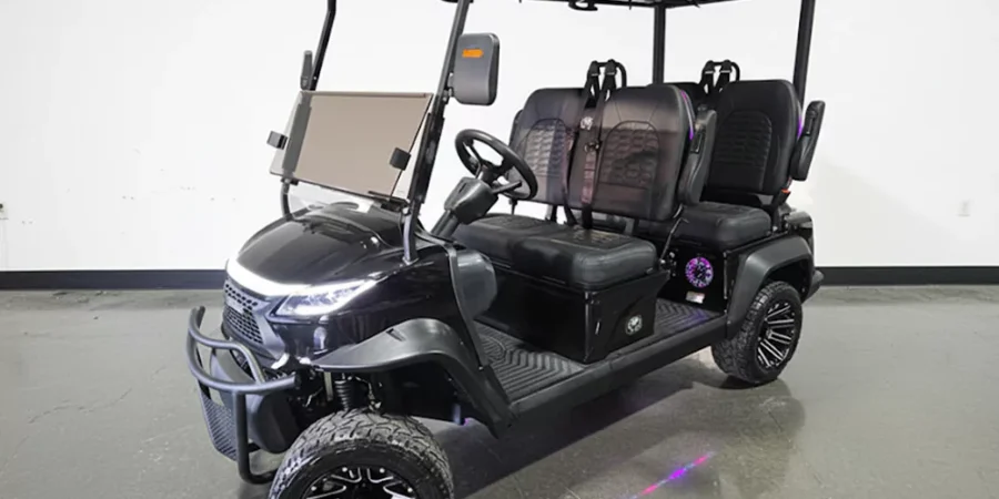 Venom EV black 6-passenger electric golf cart featuring custom black diamond seats, off-road wheels, LED accent lights, front brush guard, and roof-mounted rack.